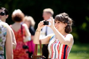 guest photographing candid at wedding